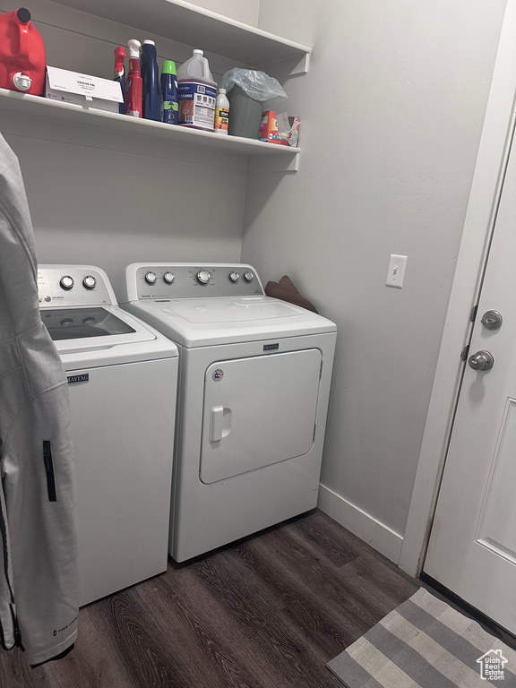 Laundry room with dark wood-type flooring and washing machine and dryer