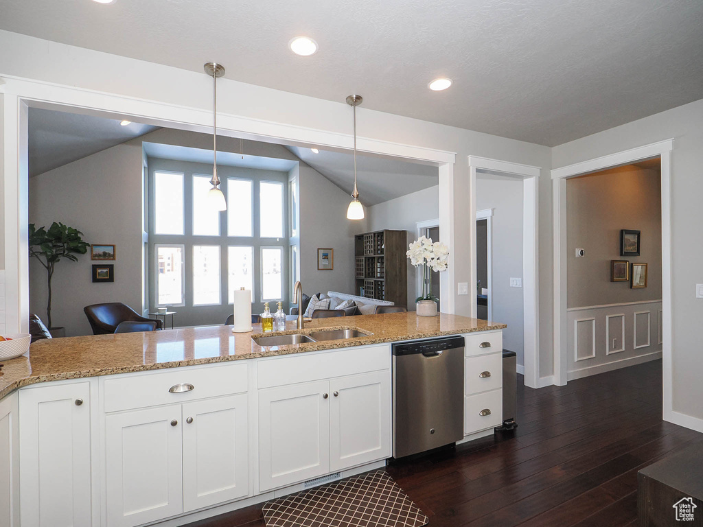 Kitchen with dishwasher, dark hardwood / wood-style flooring, white cabinets, sink, and decorative light fixtures
