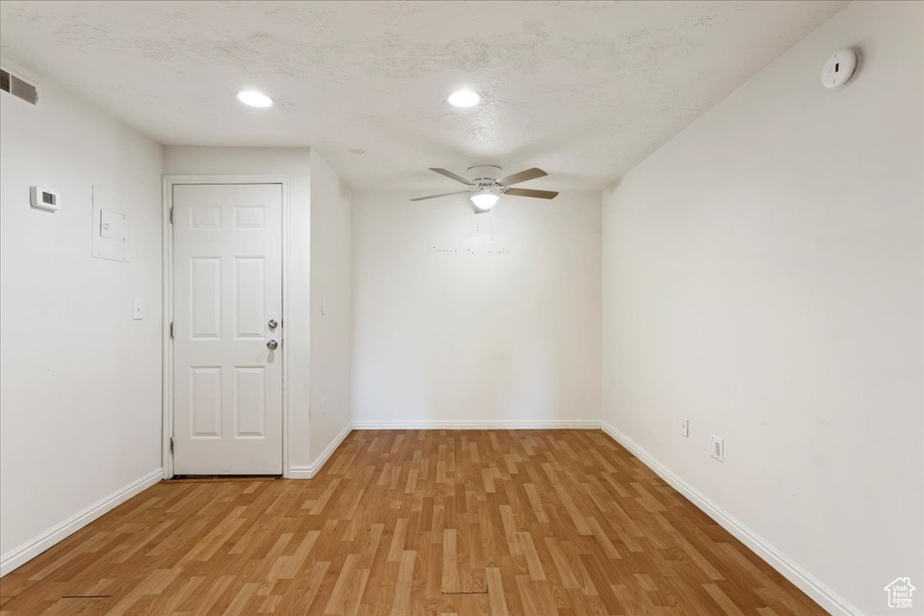 Spare room with ceiling fan and light wood-type flooring