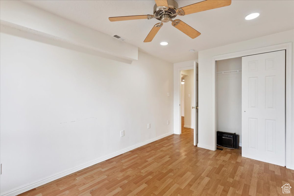 Unfurnished bedroom featuring light hardwood / wood-style flooring, ceiling fan, and a closet