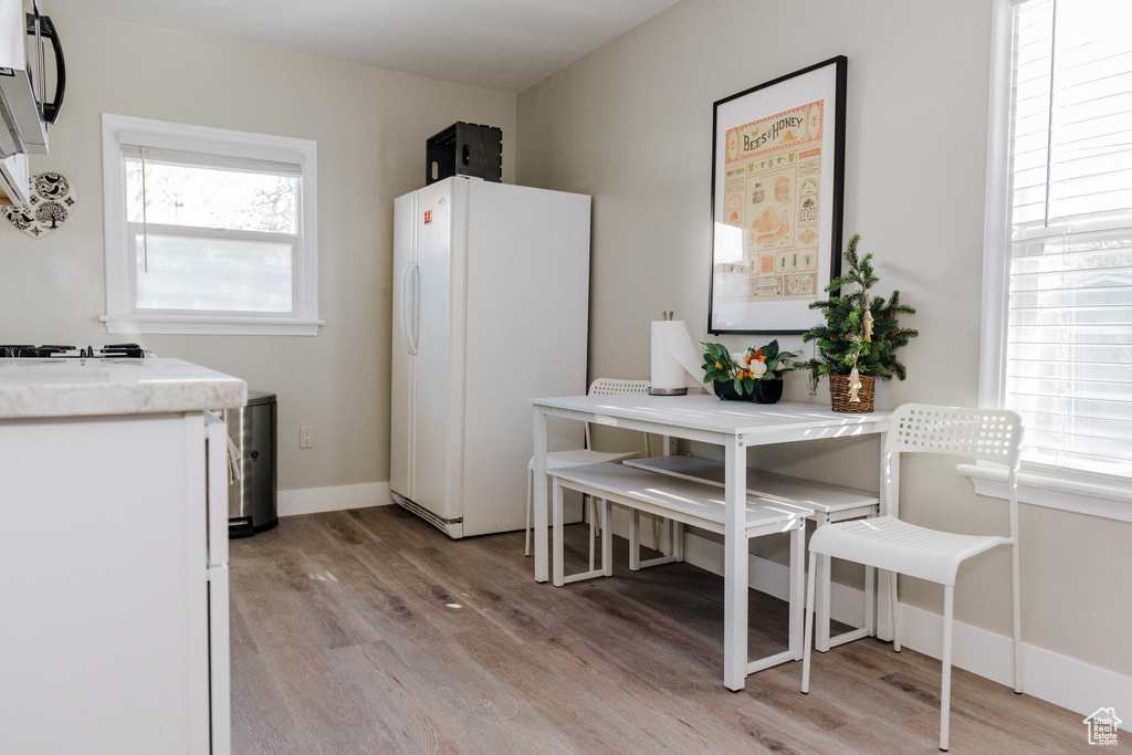Kitchen with light hardwood / wood-style floors and white refrigerator