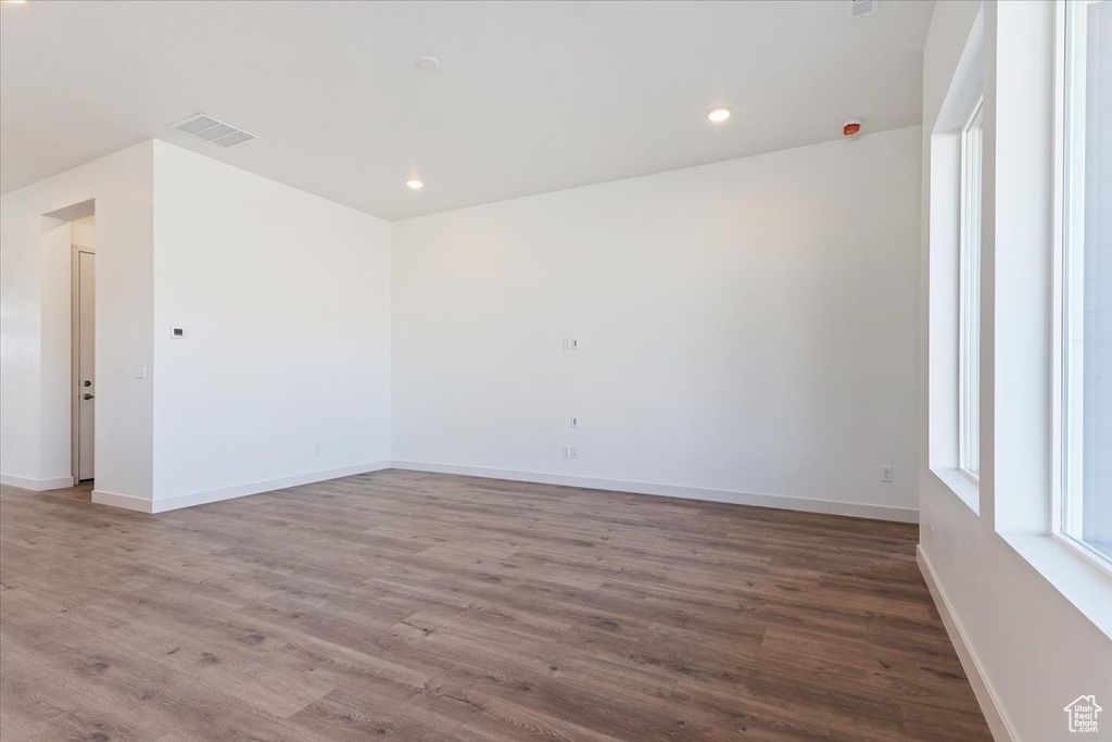 Spare room with dark hardwood / wood-style flooring