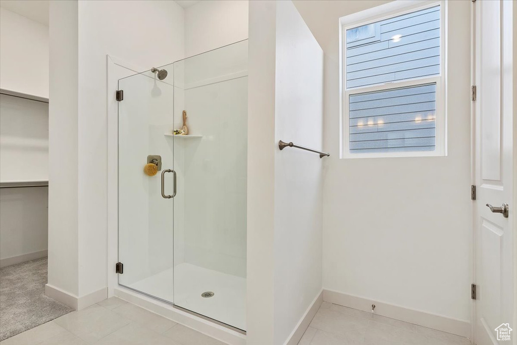 Bathroom featuring an enclosed shower and tile flooring