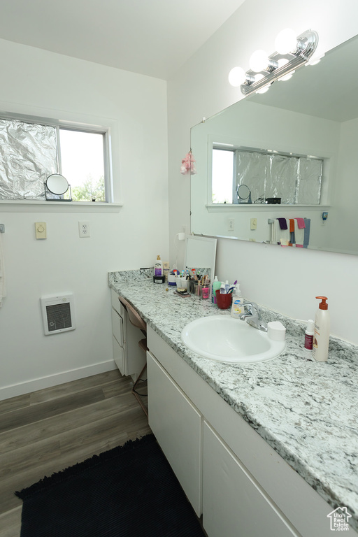 Bathroom featuring oversized vanity and wood-type flooring