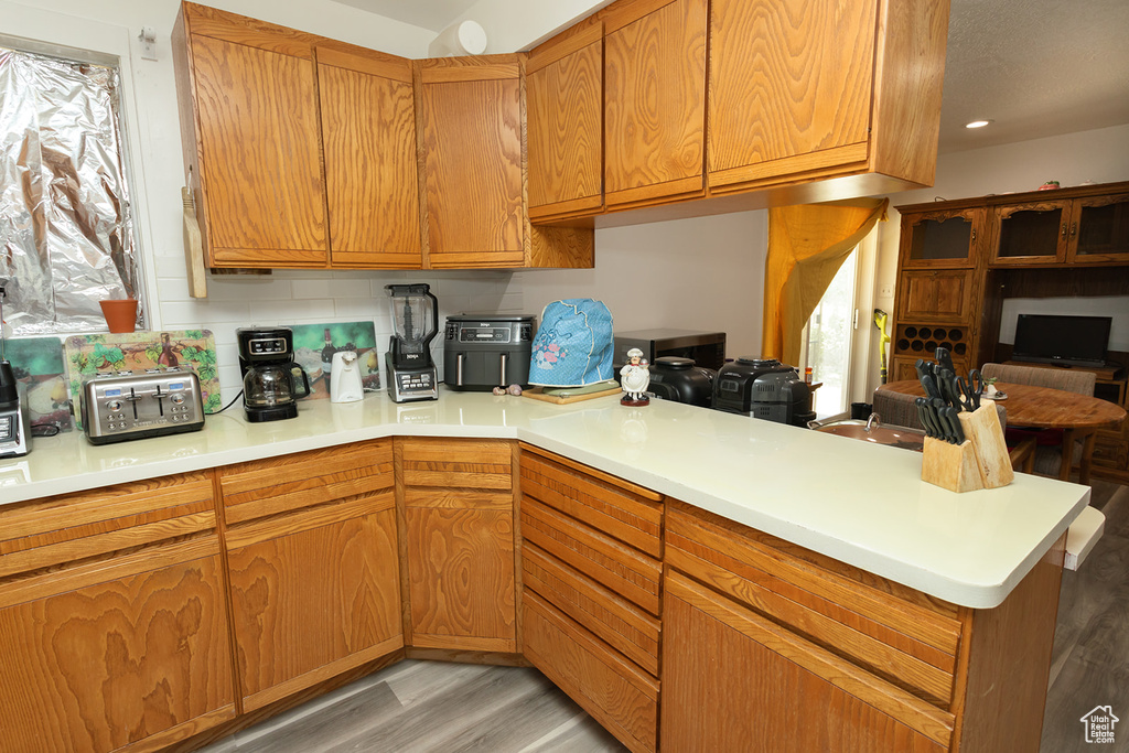 Kitchen featuring light hardwood / wood-style floors and kitchen peninsula