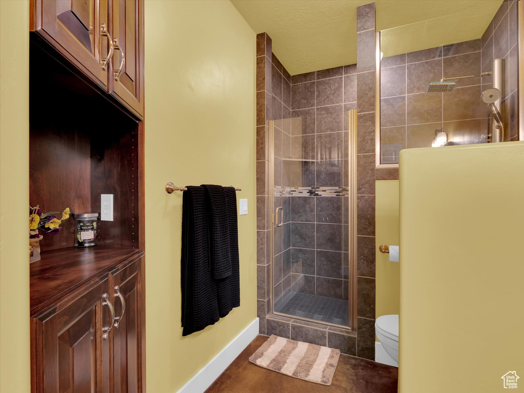 Bathroom featuring walk in shower and toilet