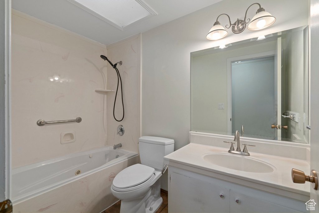 Full bathroom with vanity,  shower combination, and toilet