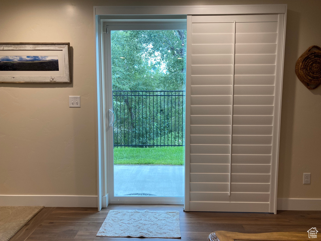 Doorway to outside featuring dark hardwood / wood-style flooring