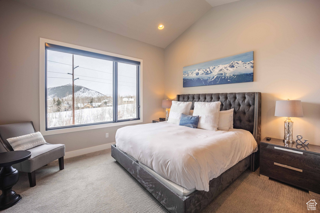 Carpeted bedroom with lofted ceiling and a mountain view