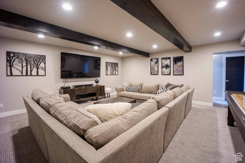 Living room featuring light carpet and beamed ceiling