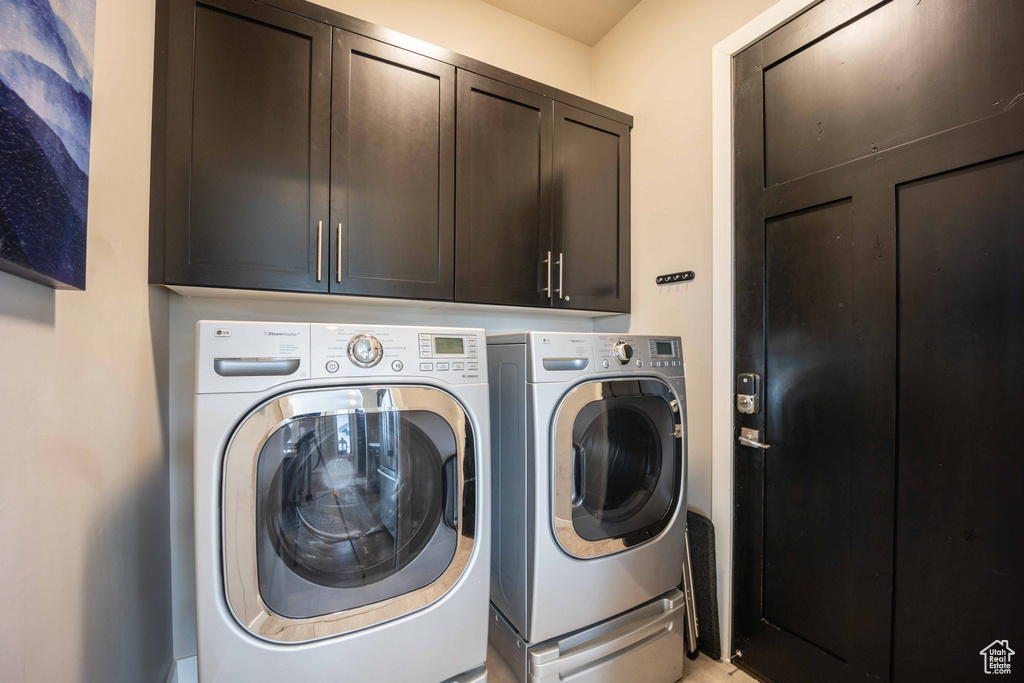 Clothes washing area with cabinets and washer and clothes dryer