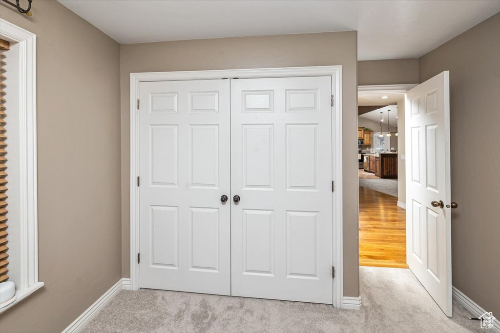 Unfurnished bedroom with light hardwood / wood-style flooring and a closet