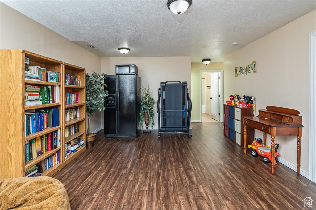 Misc room with dark hardwood / wood-style flooring and a textured ceiling