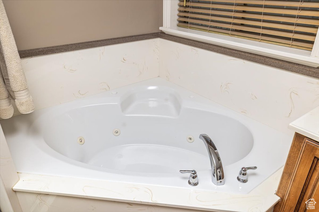 Bathroom featuring vanity and a bath to relax in