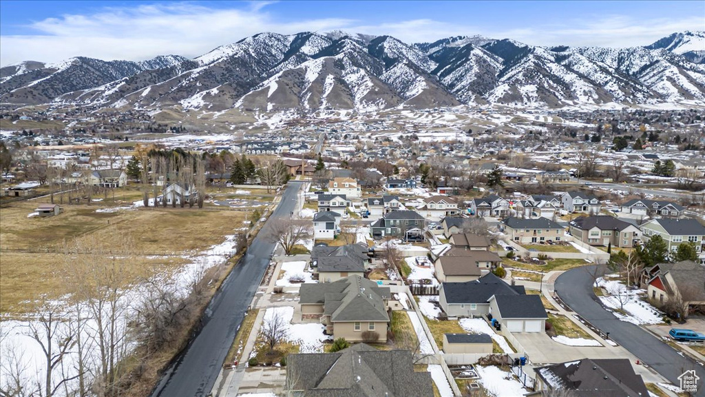 Snowy aerial view featuring a mountain view