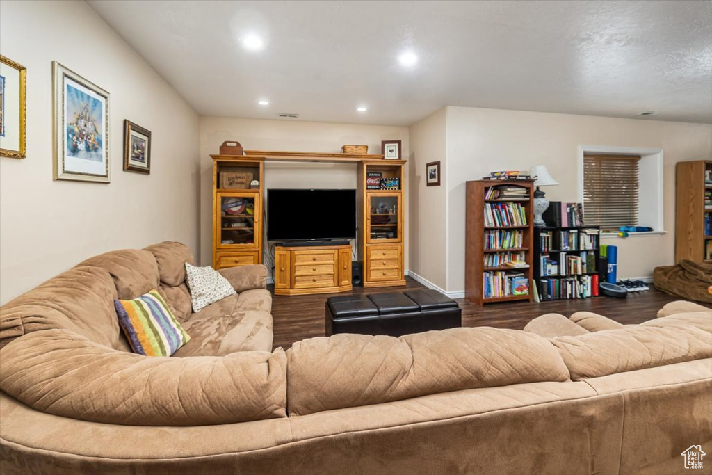 Living room with dark hardwood / wood-style flooring