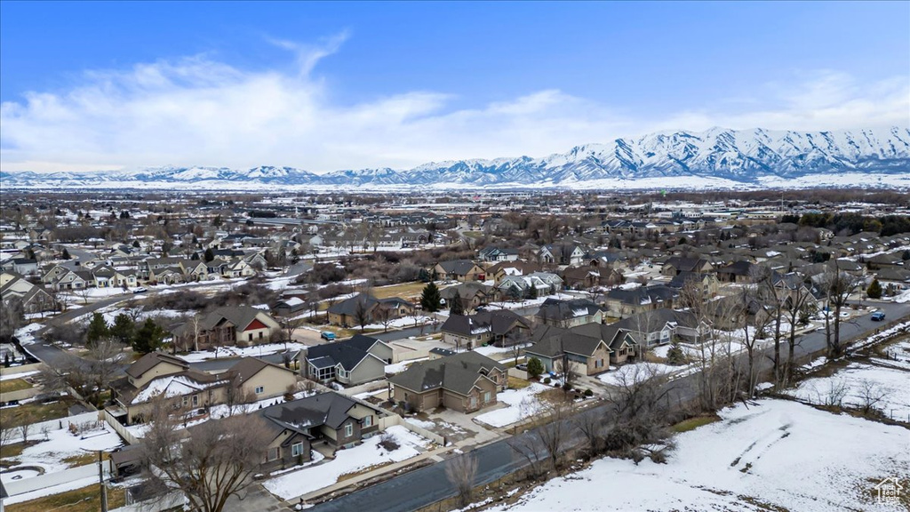 Snowy aerial view featuring a mountain view