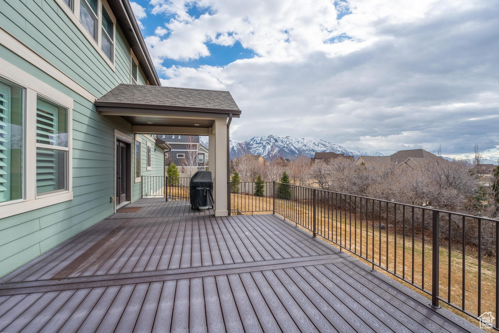 Wooden deck featuring a grill and a mountain view