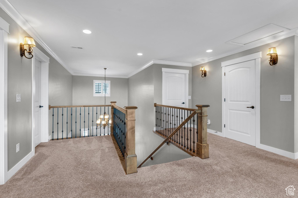 Hall featuring crown molding and light colored carpet