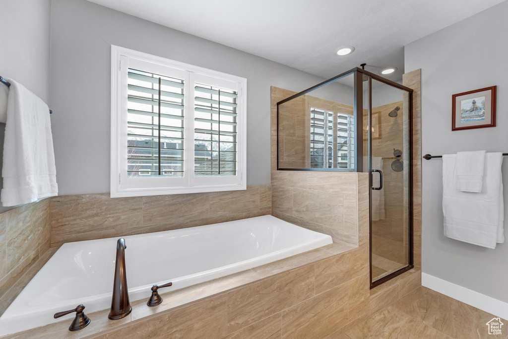 Bathroom with tile floors and independent shower and bath