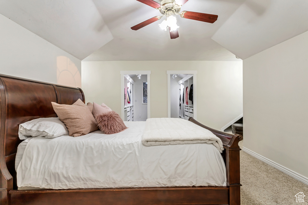 Bedroom with ceiling fan, carpet, and lofted ceiling