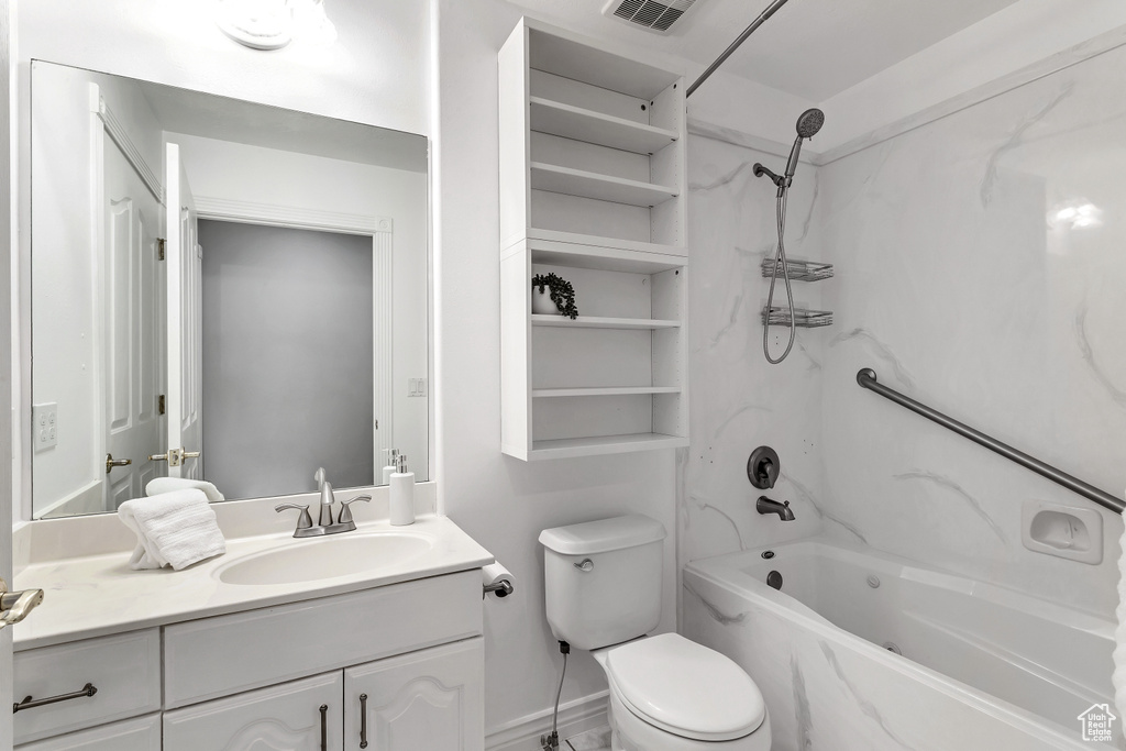 Full bathroom featuring vanity, toilet, and shower / tub combination