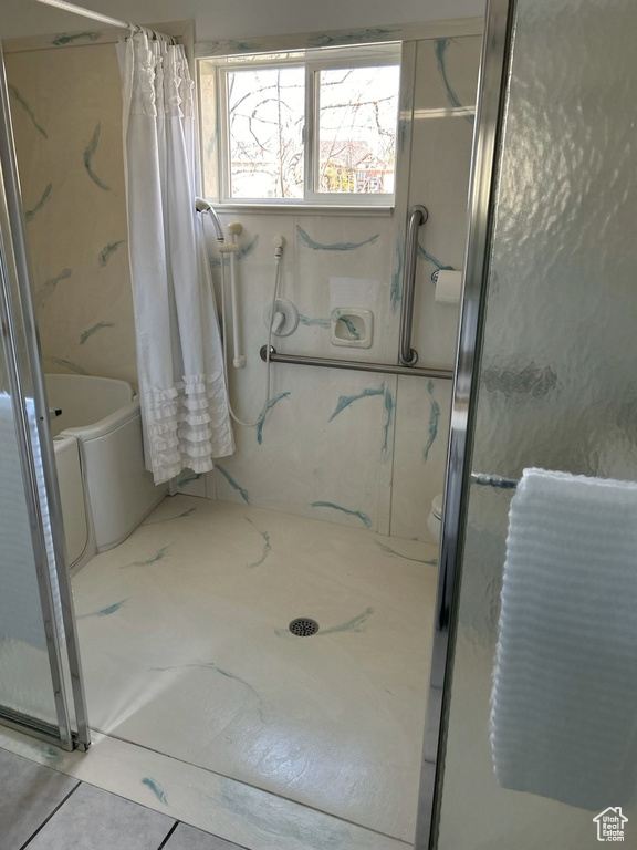 Bathroom featuring tile floors, a shower with curtain, and toilet
