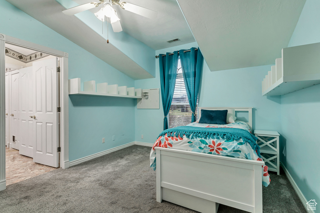 Bedroom featuring carpet floors, ceiling fan, and vaulted ceiling
