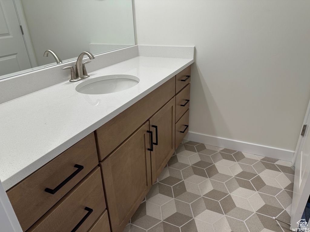 Bathroom with large vanity and tile flooring