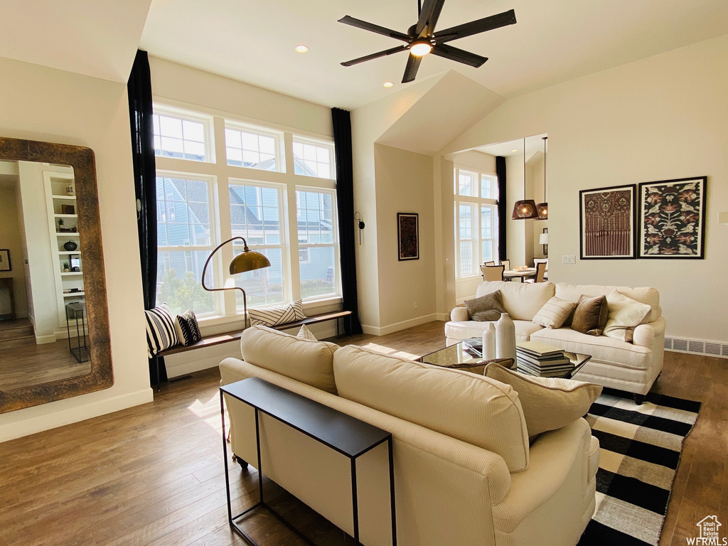 Living room featuring plenty of natural light, light hardwood / wood-style floors, and ceiling fan