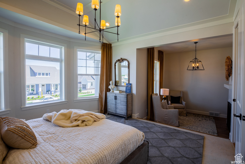 Bedroom featuring a chandelier, crown molding, and dark wood-type flooring