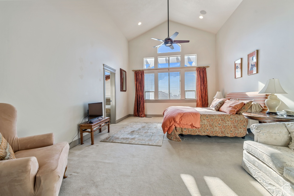Bedroom featuring high vaulted ceiling, ceiling fan, and light carpet