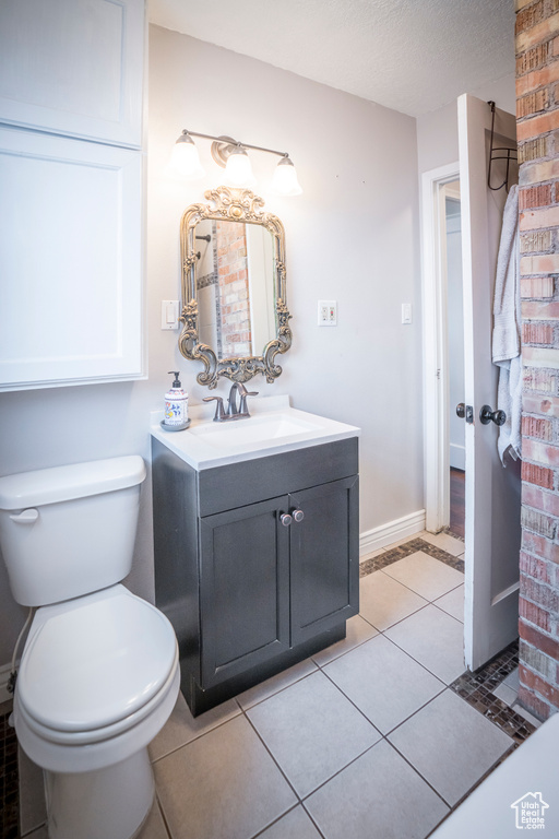 Bathroom with vanity, tile floors, a textured ceiling, and toilet