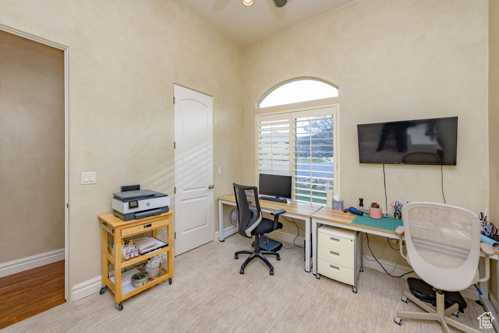 Office with light hardwood / wood-style flooring and ceiling fan