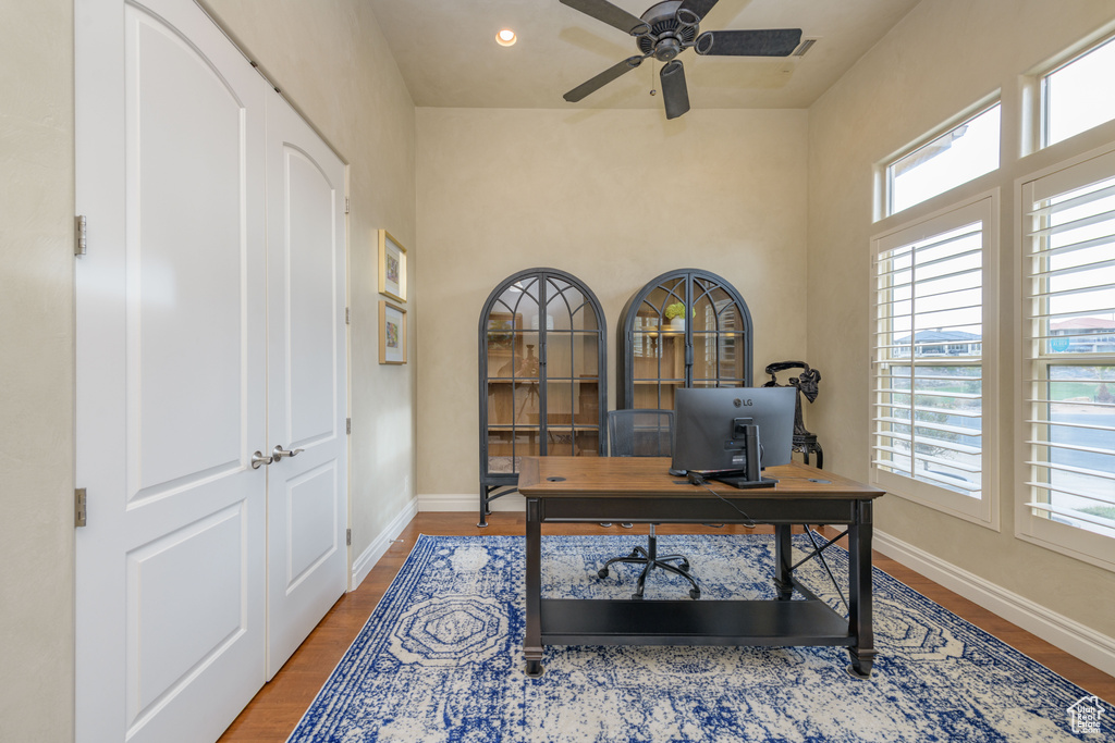Office space with ceiling fan and wood-type flooring