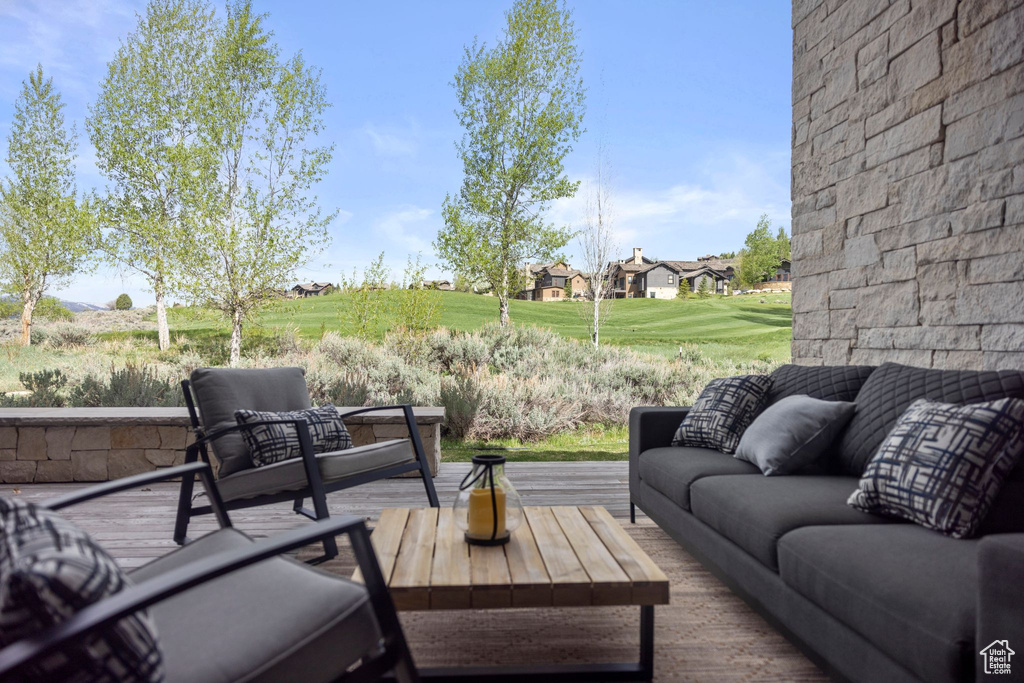 View of patio featuring an outdoor living space and a wooden deck