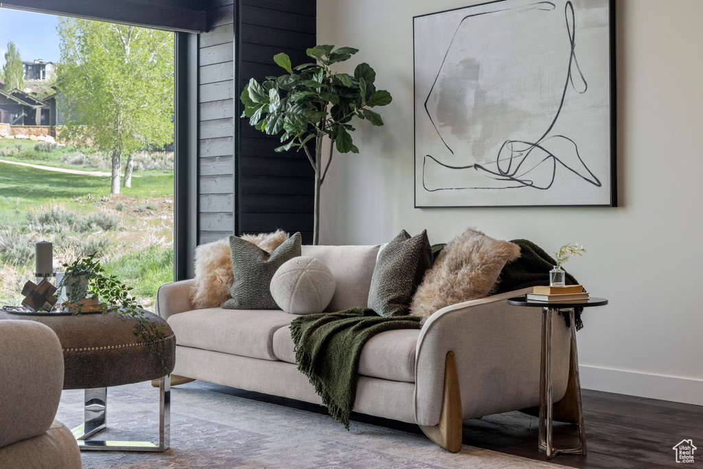 Living area with baseboards and wood finished floors