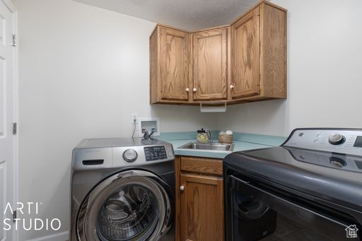 Laundry room with separate washer and dryer, cabinets, hookup for a washing machine, and sink