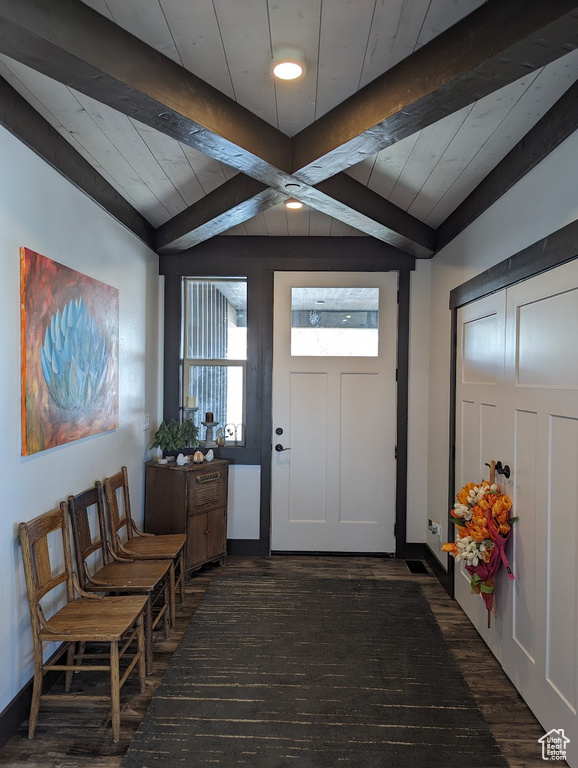 Entrance foyer featuring dark hardwood / wood-style floors and beamed ceiling