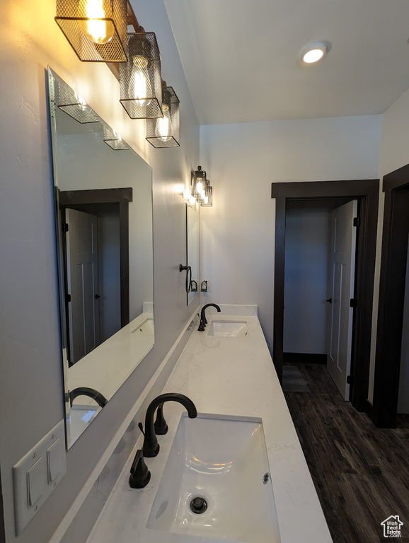 Bathroom featuring hardwood / wood-style floors, double sink, and large vanity