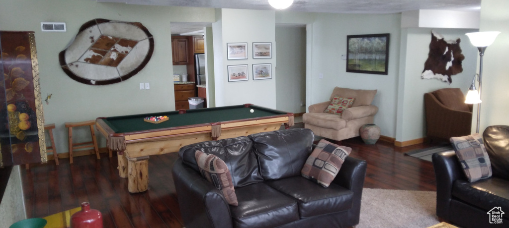 Living room with dark wood-type flooring and billiards