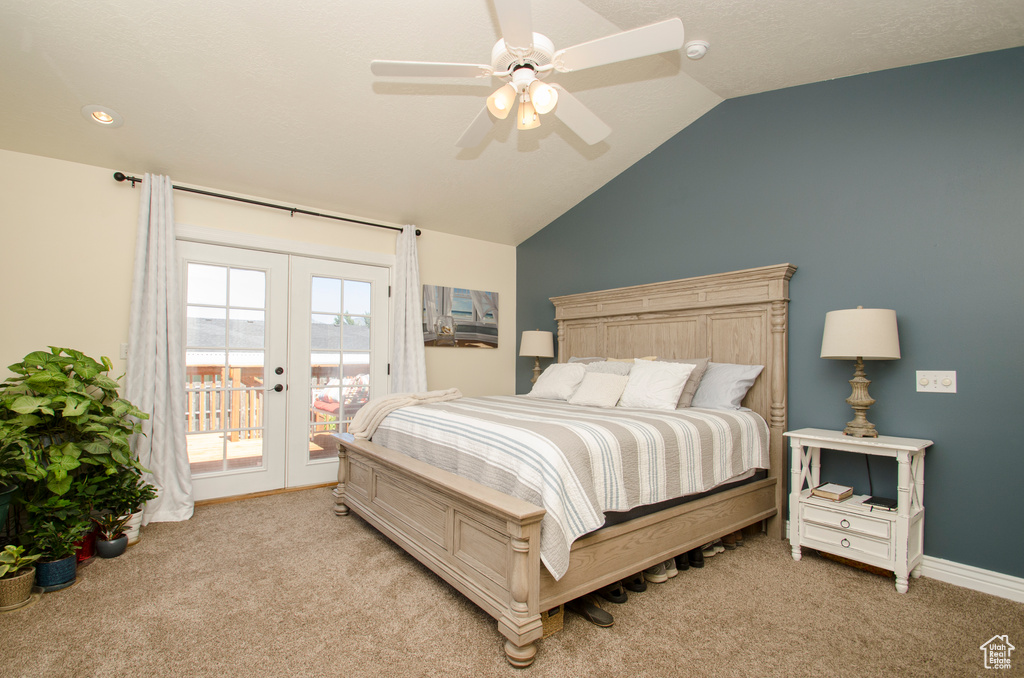 Carpeted bedroom featuring french doors, access to exterior, vaulted ceiling, and ceiling fan