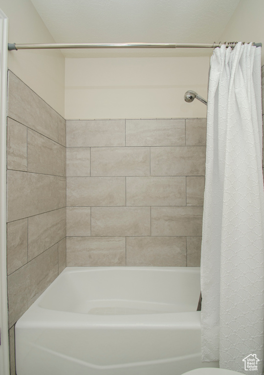 Bathroom featuring shower / bath combination with curtain