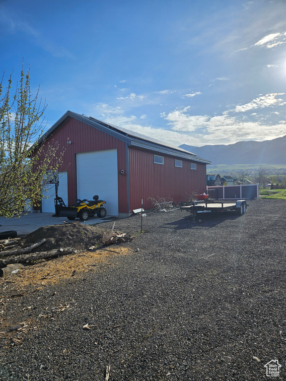 View of outdoor structure with a garage and a mountain view