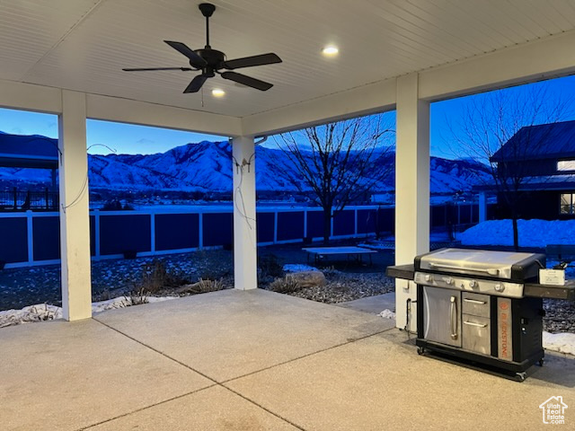 View of patio / terrace featuring ceiling fan and a mountain view