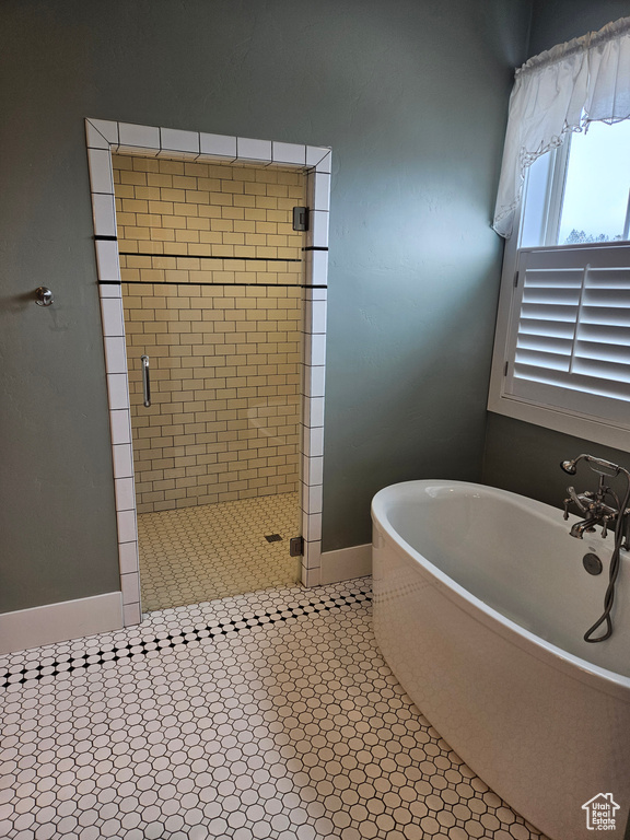 Bathroom featuring independent shower and bath and tile flooring