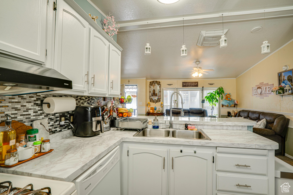 Kitchen featuring dishwasher, ceiling fan, kitchen peninsula, hanging light fixtures, and backsplash