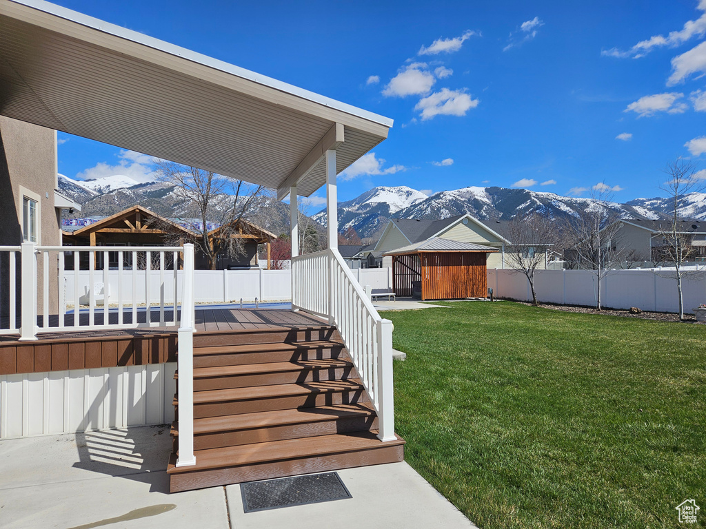 View of yard with a deck with mountain view