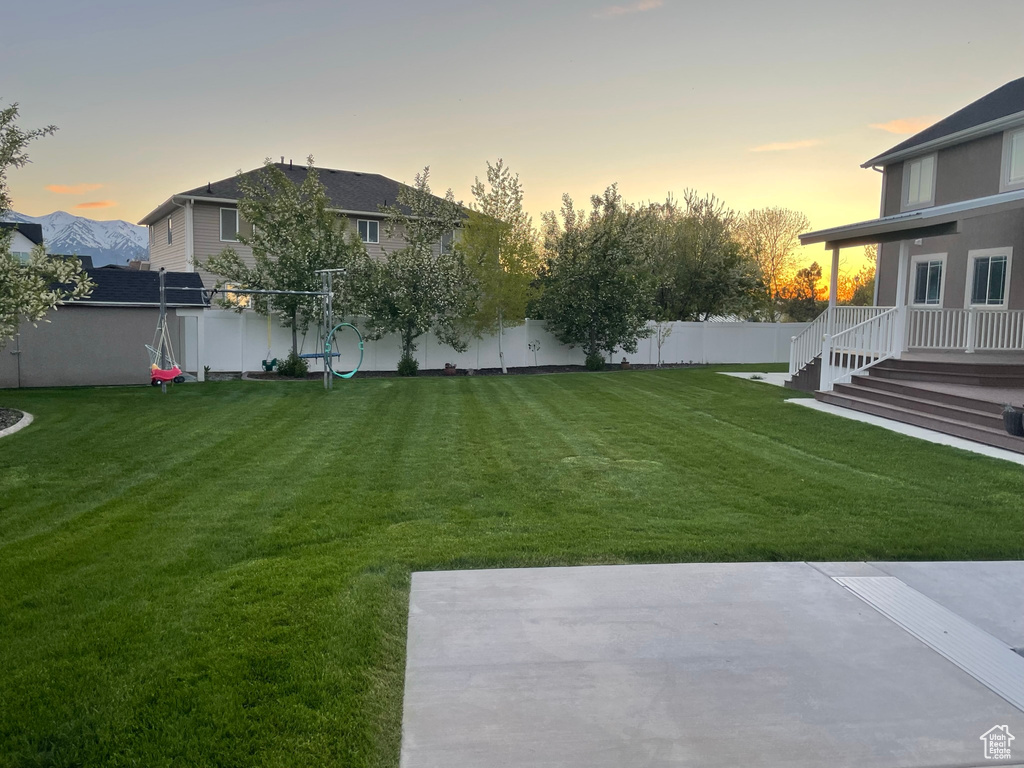 Yard at dusk with a patio area