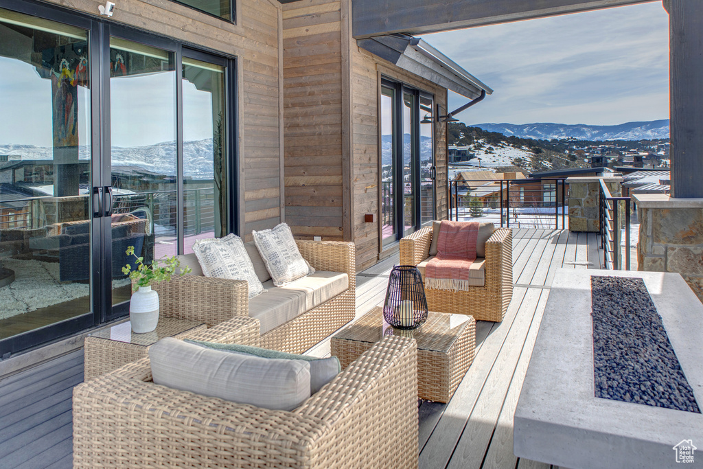 Balcony featuring an outdoor living space and a mountain view